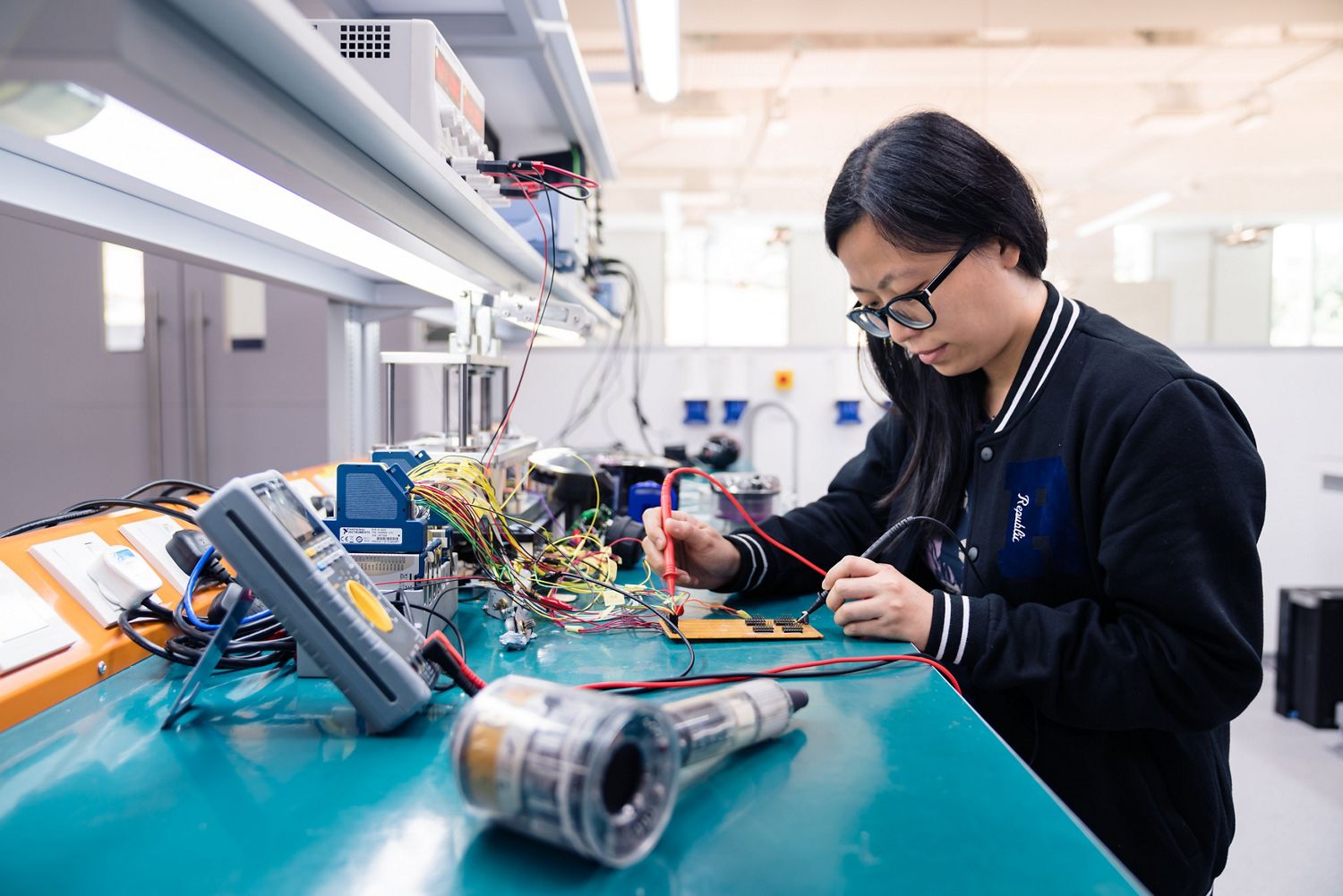 Engineer working on electronics of a Dyson Supersonic hair dryer.
